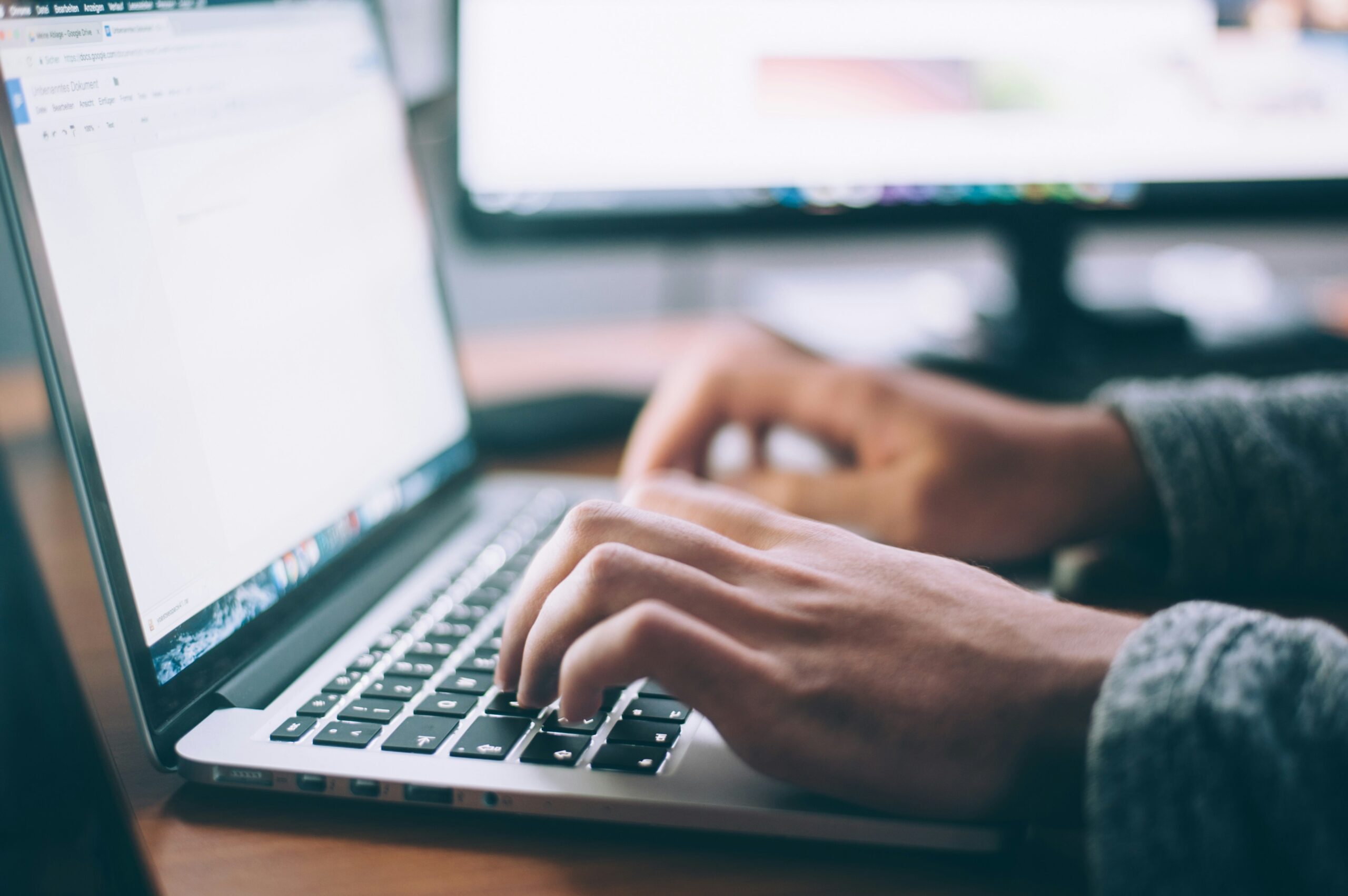 Person typing on laptop keyboard, optimizing Microsoft 365 settings